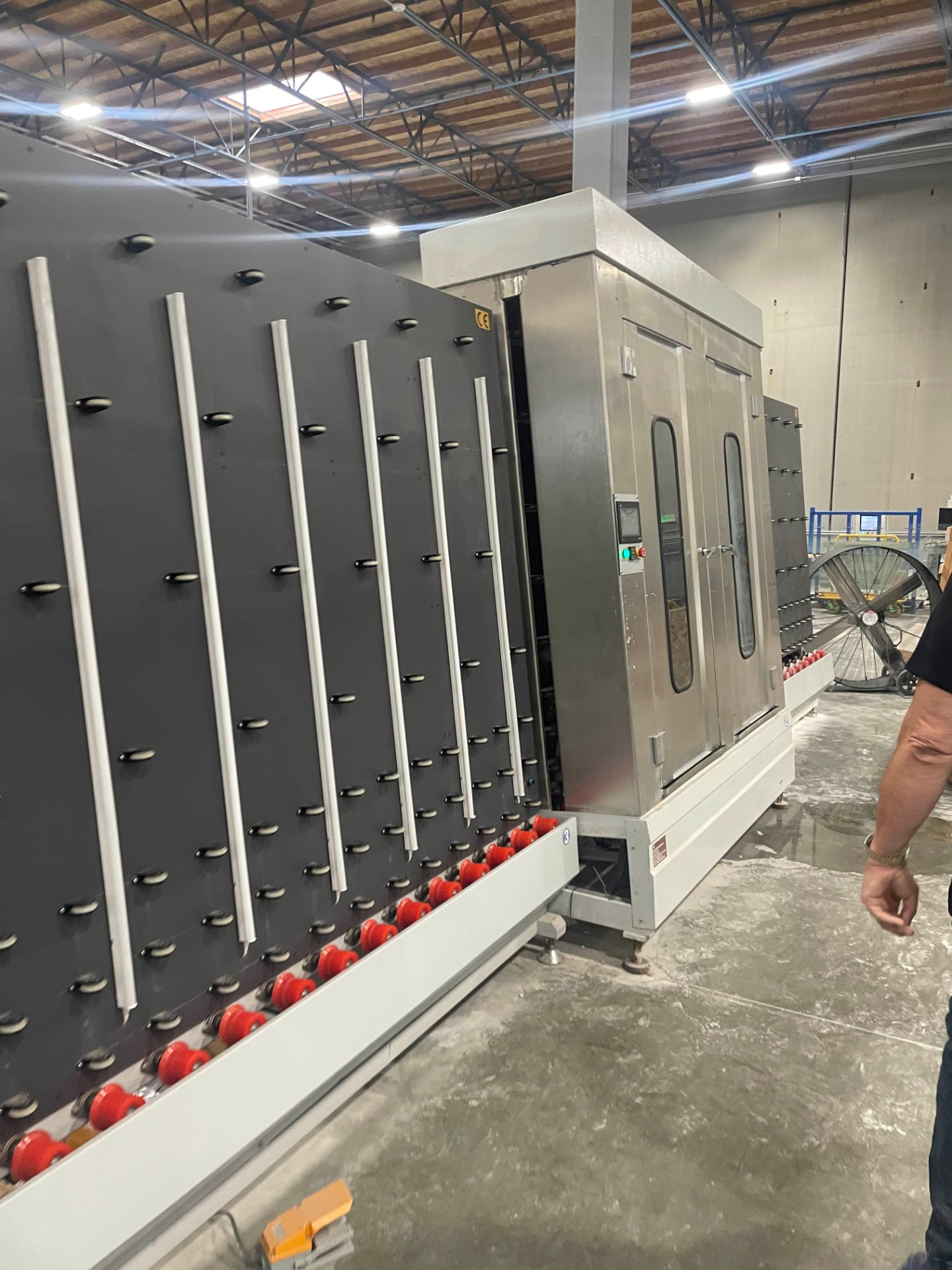 The sealed-unit press. Spacer, desiccant, and primary seal are set here — the components that decide whether a glazing package lasts five years or twenty-five.