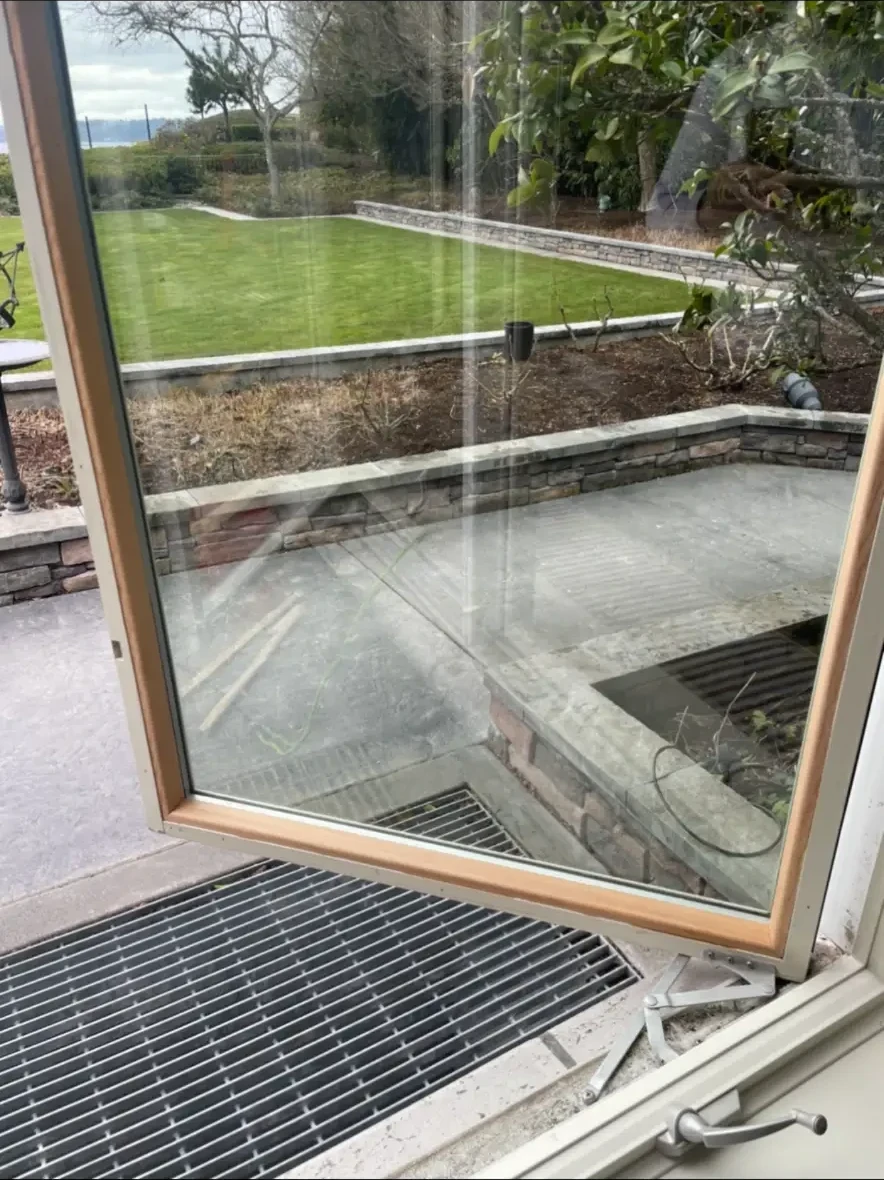A restored casement after hardware adjustment and weatherseal renewal — closing on its full compression seal again.