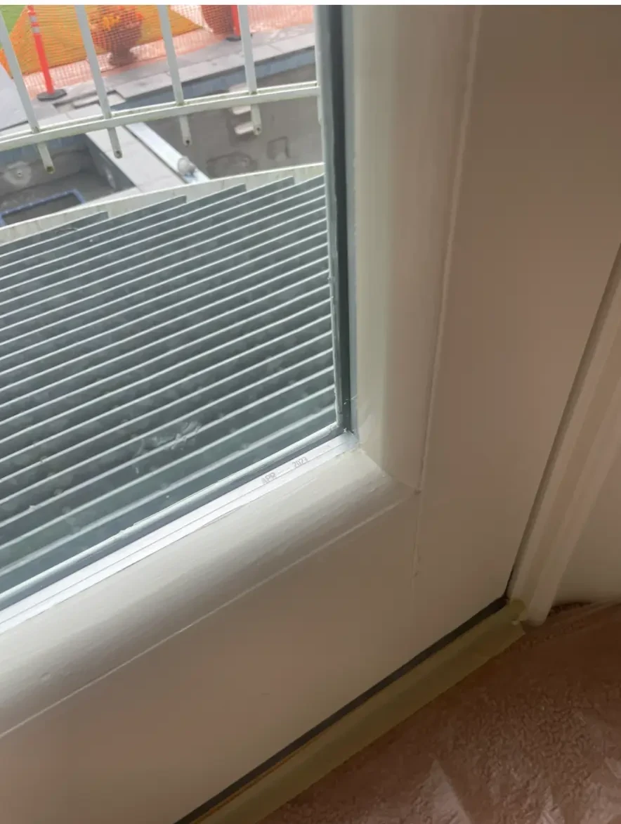 Finished interior jamb and sill of a completed opening. From inside the room there is no evidence that any work occurred.
